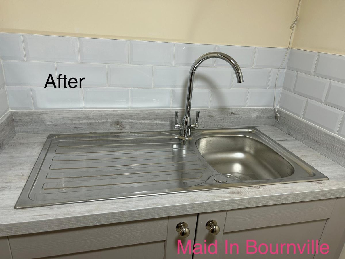 The same kitchen sink and drainer gleaming after cleaning