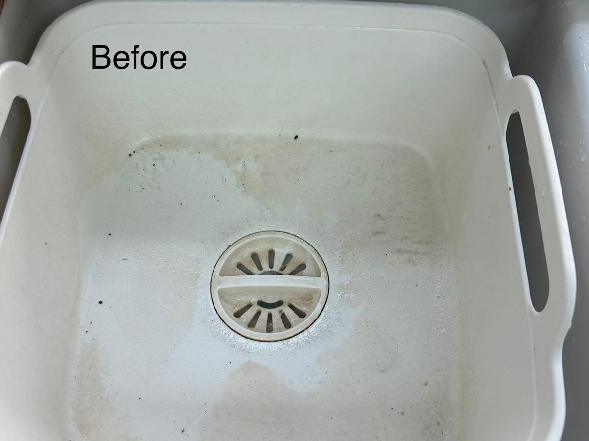 White plastic sink bowl with grime and stains before cleaning