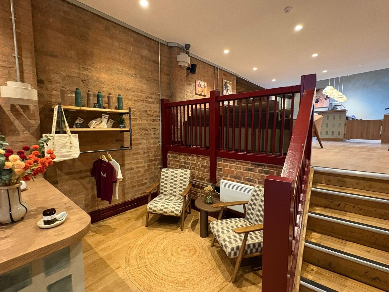 Shop and seating area with wooden flooring after a commercial clean by Maid in Bournville
