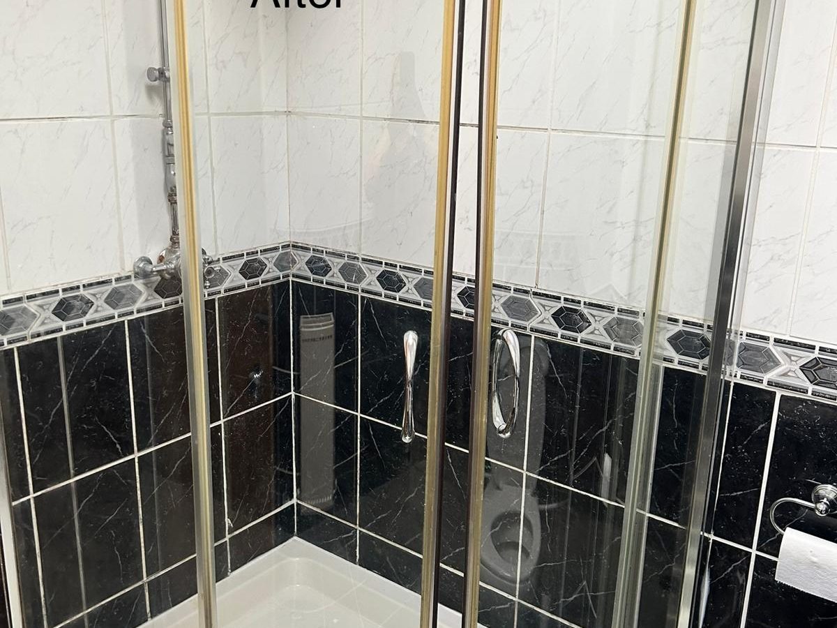The same shower enclosure with clear glass doors after cleaning